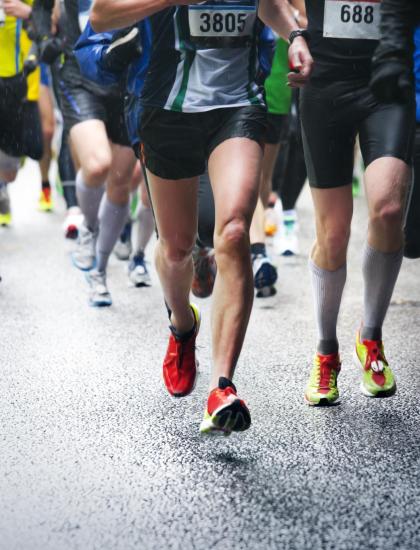 Corridori partecipano a una maratona sotto la pioggia.