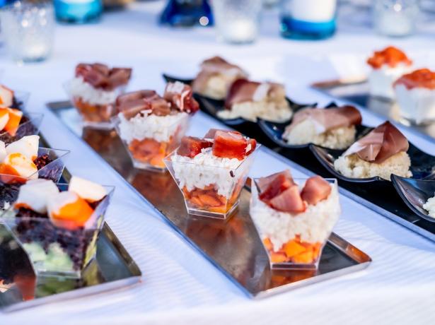 Delicious gourmet appetizers served in small portions on trays.