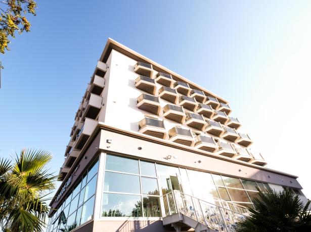 Modern building with unique balconies and blue sky.